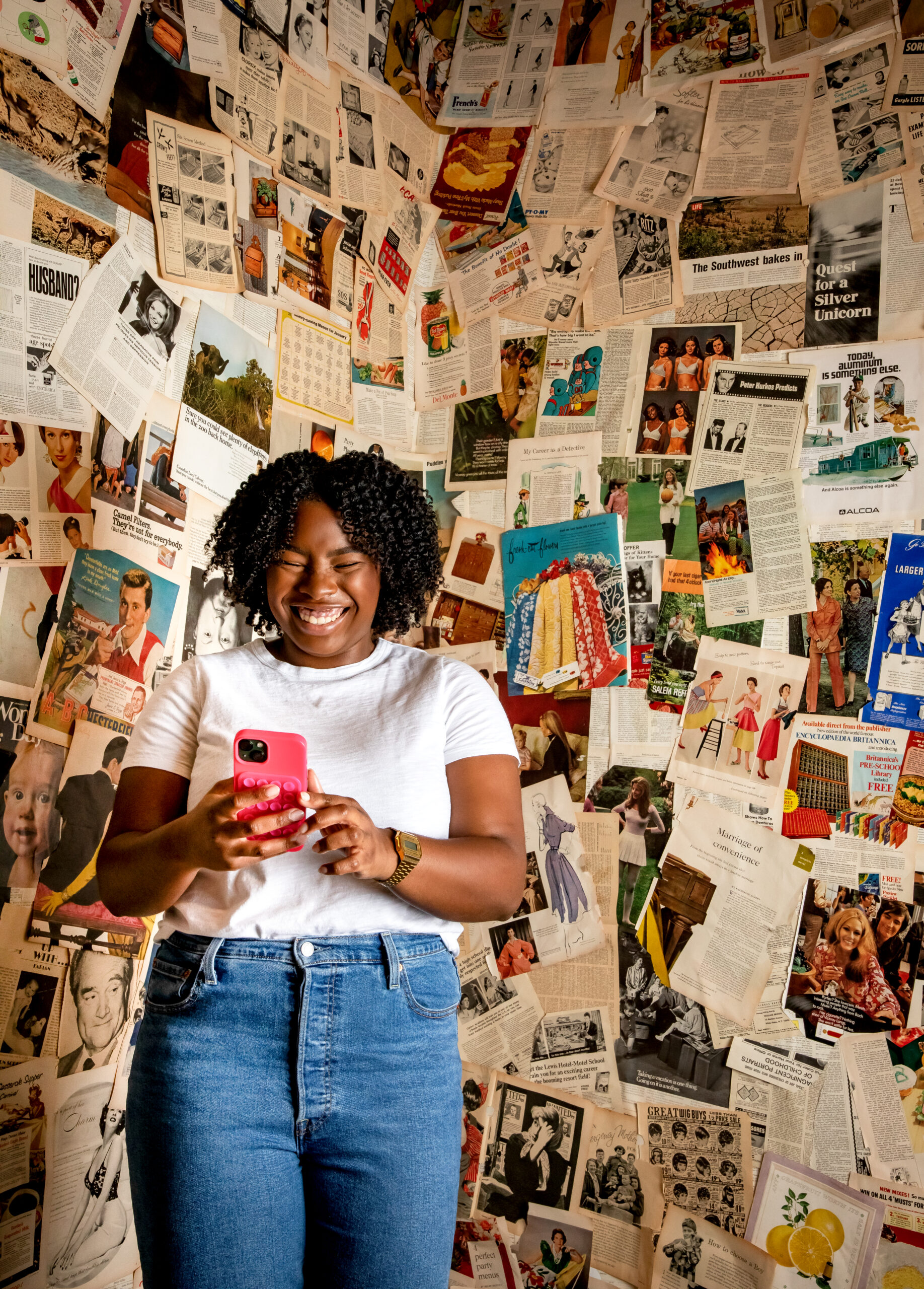 Smiling woman looking down at cell phone in her hands